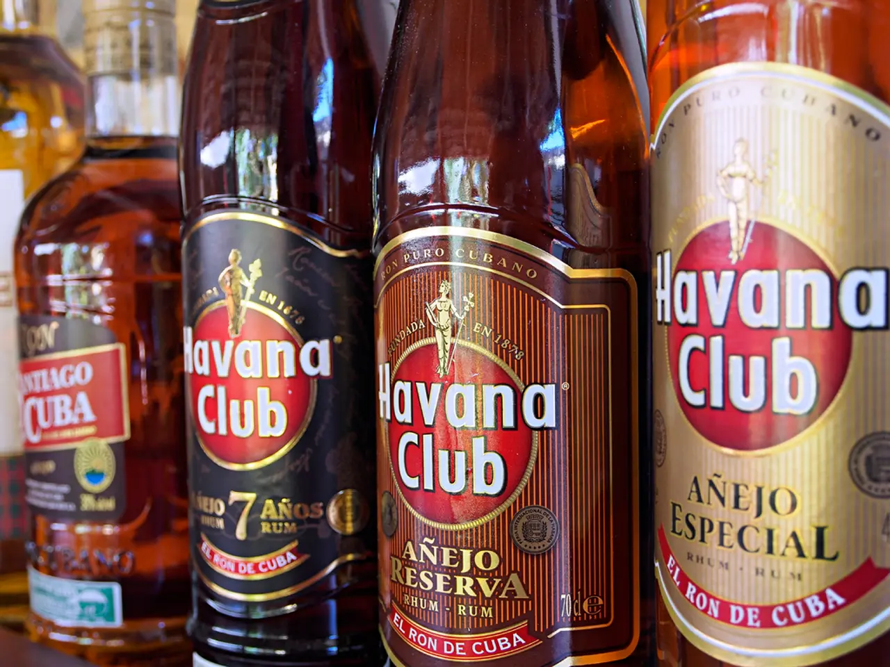 In this image there are a few bottles with some drink arranged in the shelf's and some label-lungs...