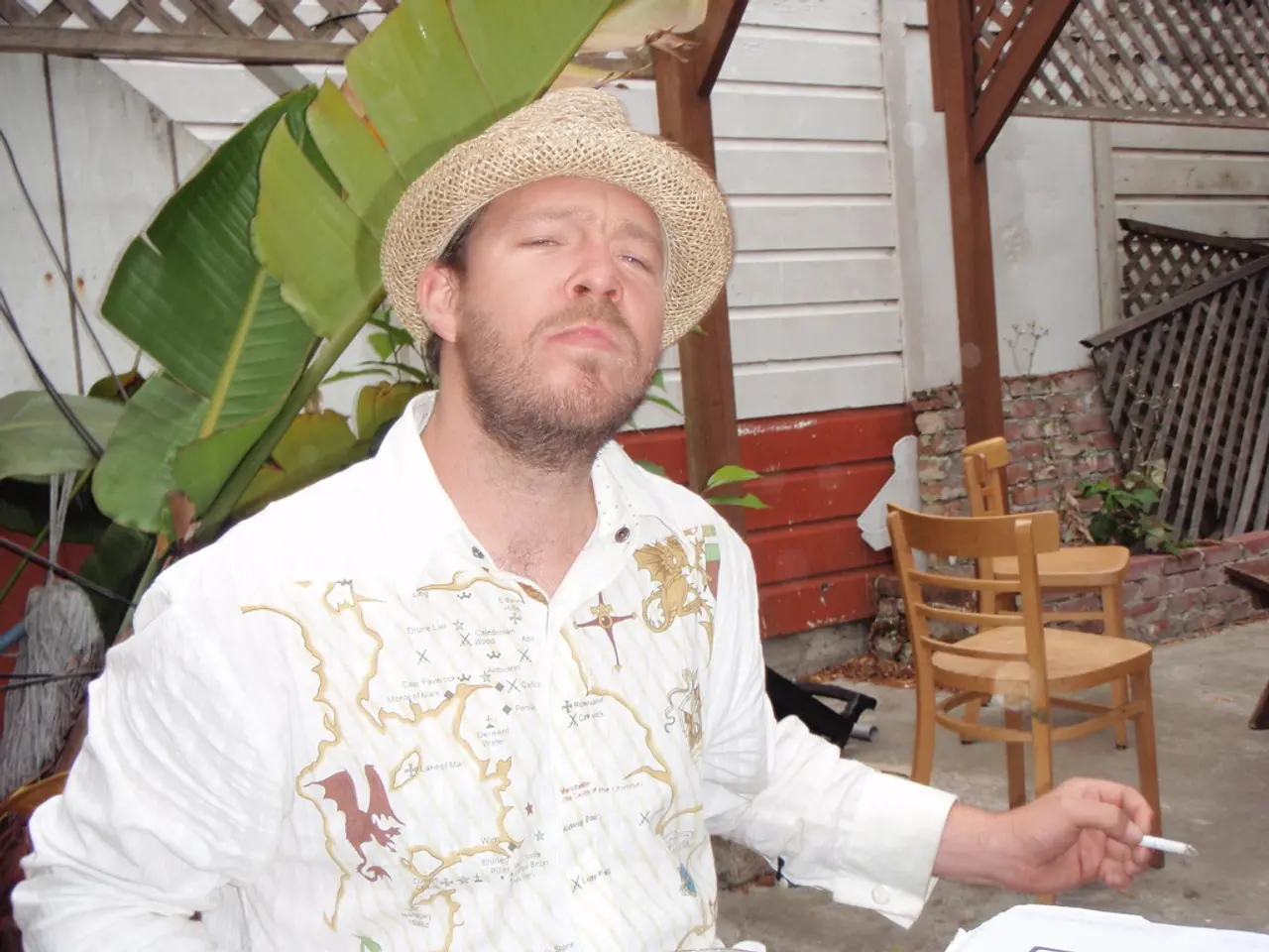 in this picture there is a man who is sitting at the left side of the image and he is smoking,...