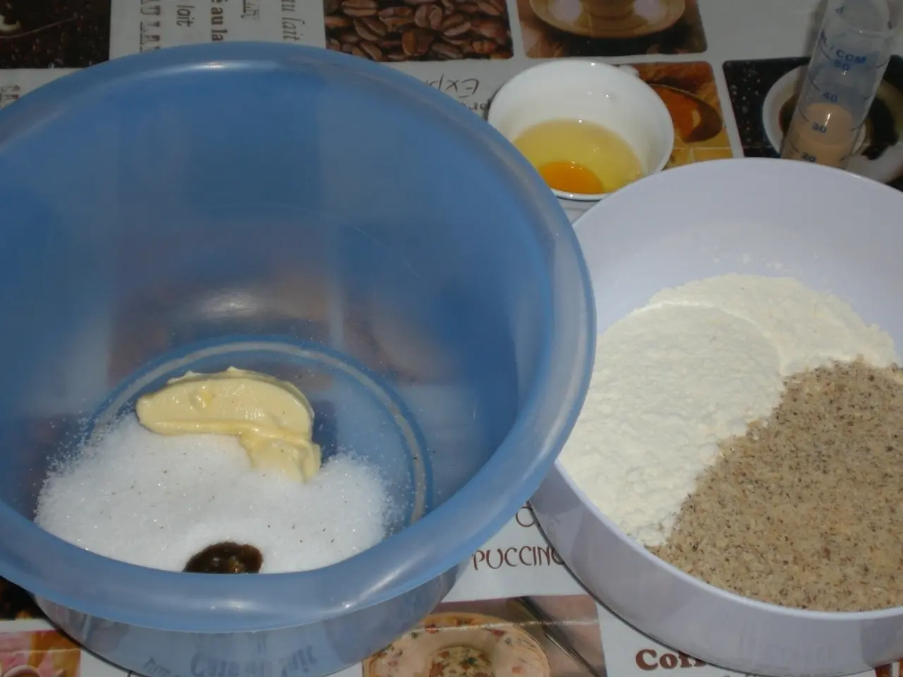 In this image on a table there are three bowls. In the bowels there are some food ingredients. This...