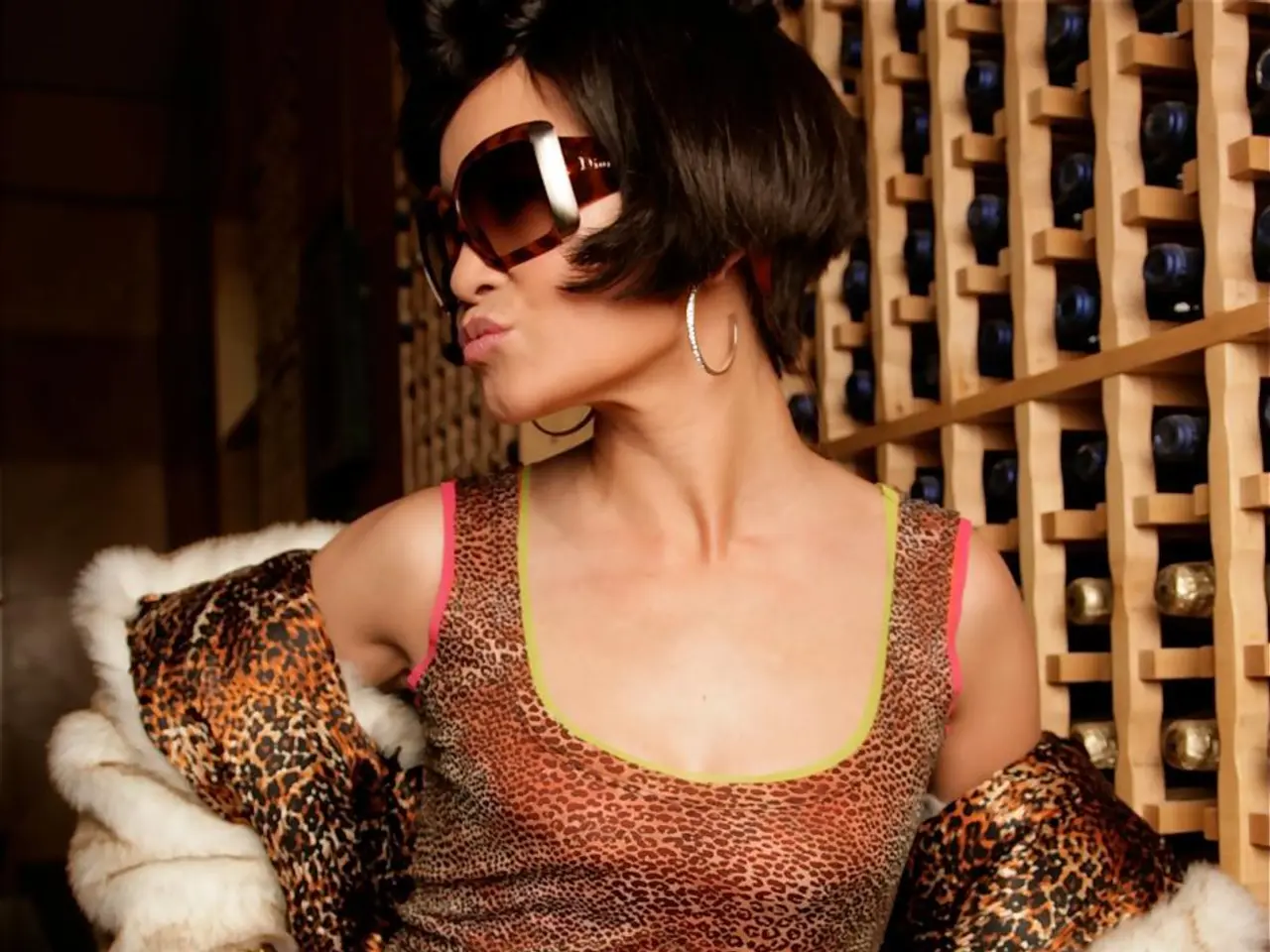 In this image we can see a lady wearing goggles and she has a short hair. On the right side of the...