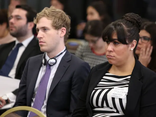 It's questionable if driving while wearing headphones is against the law.