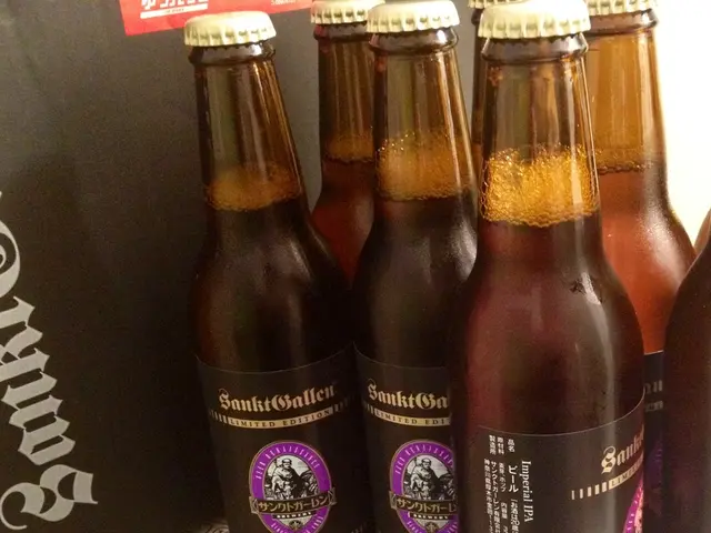 There are some bottles placed in the shelf on a paper in this picture.