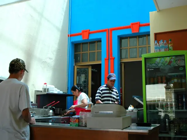 In this image there are three persons who are doing work at kitchen and at the right side of the...