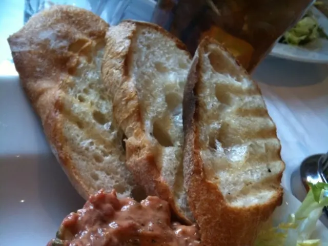 In this picture I can observe some food which is in brown and green color. In the top of the...