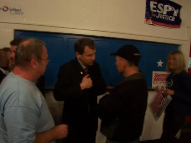 In the image there are a group of people and some of them are talking to each other and on the...